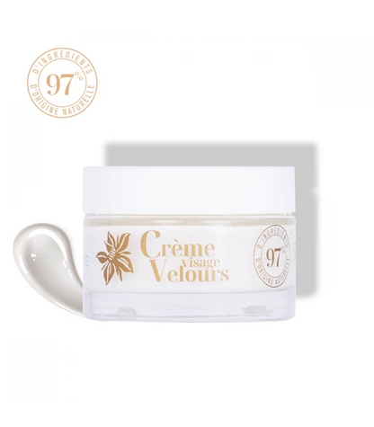 A jar of 'Crèmeissant Velours' velvet face moisturizer moisturizing face cream with a label indicating it is 97% natural. The jar is white with gold accents and the cream inside is visible, showing a light texture.