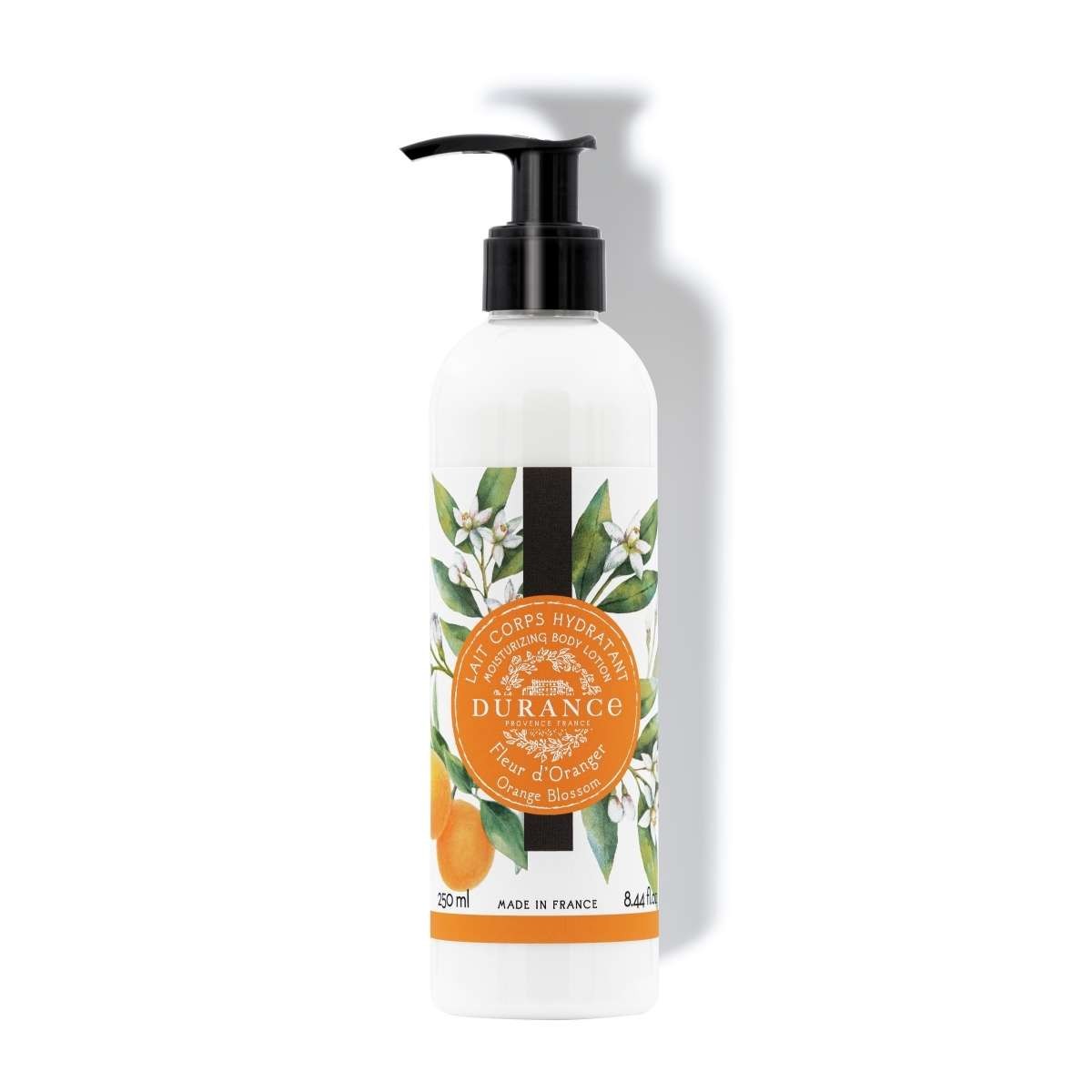 A pump bottle of Durance Orange Blossom body lotion with a white and orange label, indicating that it is made in France and has a capacity of 250 ml.