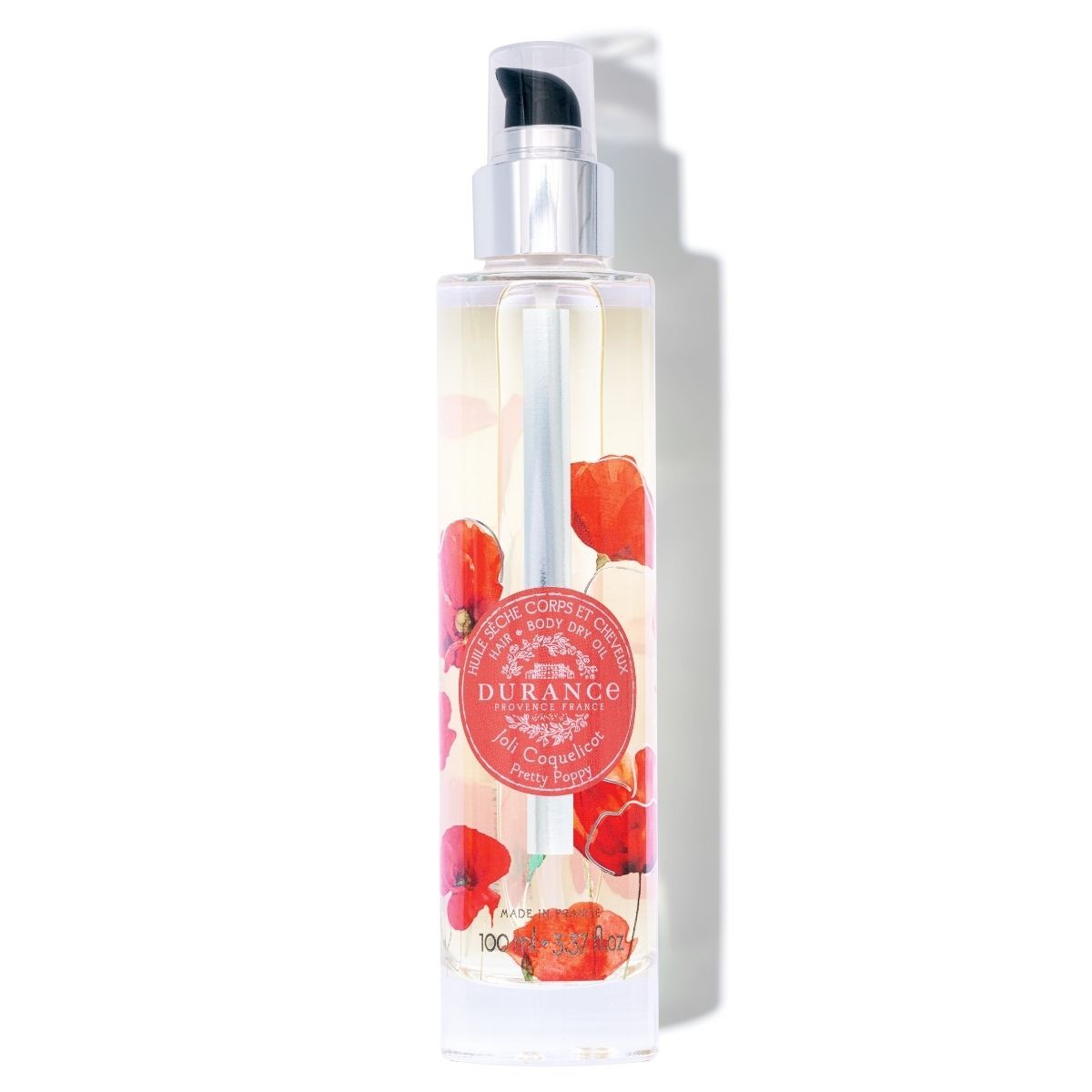 A clear bottle of Durance hair and body dry oil with a black cap, featuring a label with red poppy flowers and the brand's logo.Pretty Poppy - Hair & Body Dry Oil