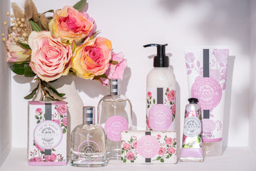 Collection of beauty products with floral design on a white background. Rose Petal Lotion