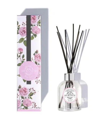 A clear glass reed Rose_Petal fruity and tangy diffuser with a floral design on the packaging, 